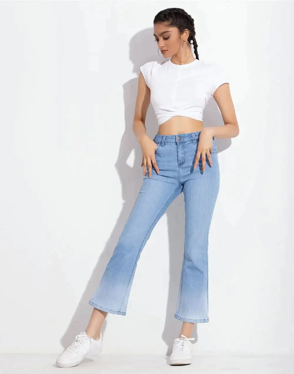 a woman in a white shirt and jeans