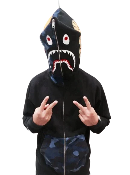 a young boy wearing a black hoodie with a shark face