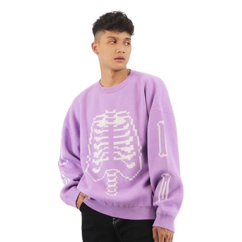 a young boy wearing a purple sweater with a skeleton on it