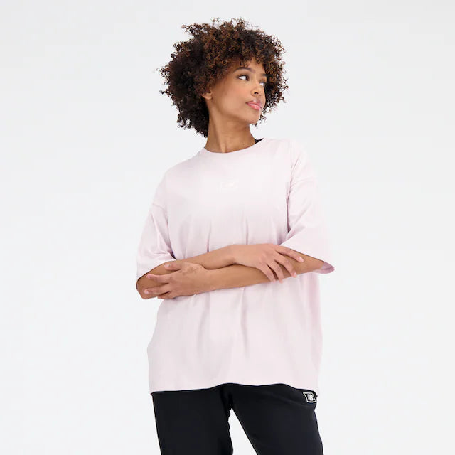 a woman in a pink shirt and black pants