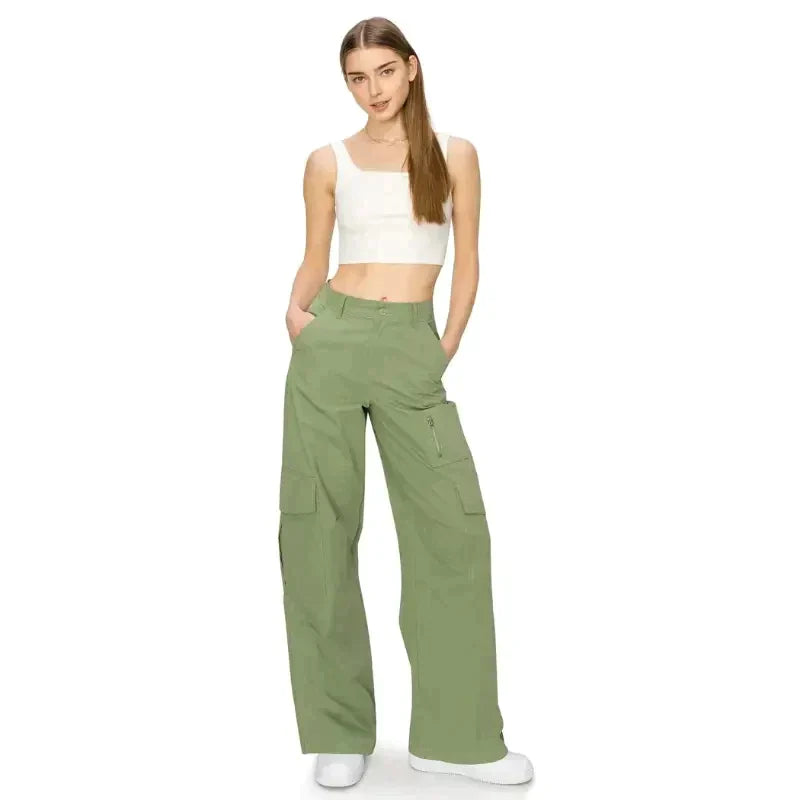 a woman in a white top and green cargo pants